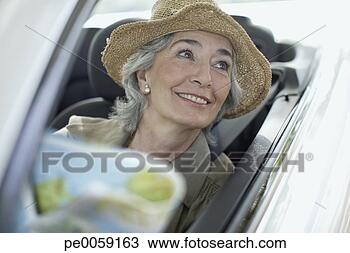 Stock Photo - woman wearing 
hat smiling and 
driving a convertible 
car. fotosearch 
- search stock 
photos, pictures, 
images, and photo 
clipart