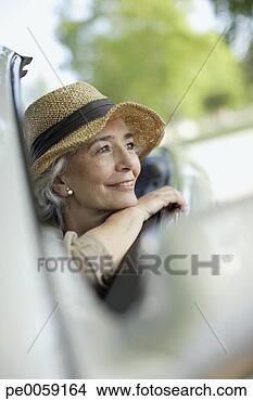 Stock Photo - woman wearing 
hat smiling in 
a convertible 
car. fotosearch 
- search stock 
photos, pictures, 
images, and photo 
clipart