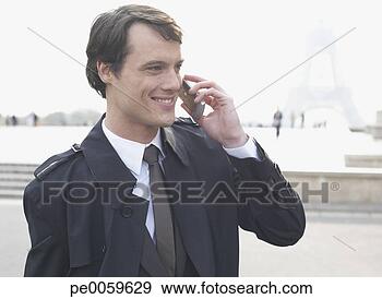Stock Photograph - businessman outdoor 
on cellular phone 
by eiffel tower. 
fotosearch - search 
stock photos, 
pictures, images, 
and photo clipart
