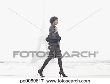 Picture - businesswoman 
walking in plaza 
by eiffel tower. 
fotosearch - search 
stock photos, 
pictures, images, 
and photo clipart
