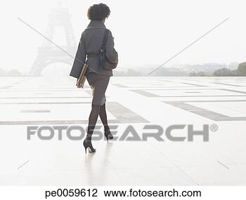 Stock Photo - businesswoman 
walking through 
plaza near eiffel 
tower. fotosearch 
- search stock 
photos, pictures, 
images, and photo 
clipart