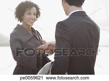 Stock Photography - two businesspeople 
outdoors shaking 
hands. fotosearch 
- search stock 
photos, pictures, 
images, and photo 
clipart