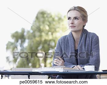 Stock Image - woman on outdoor 
patio with mug. 
fotosearch - search 
stock photos, 
pictures, images, 
and photo clipart