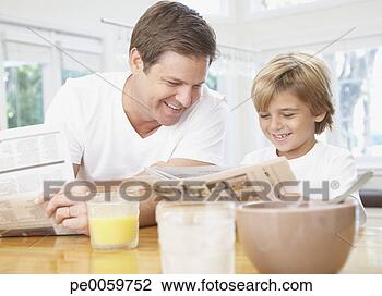 Stock Photo - man and young 
boy in kitchen 
reading newspaper. 
fotosearch - search 
stock photos, 
pictures, images, 
and photo clipart