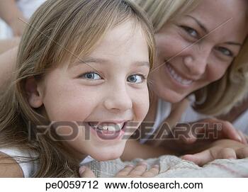 Stock Photo - woman and young 
girl lying on 
bed. fotosearch 
- search stock 
photos, pictures, 
images, and photo 
clipart