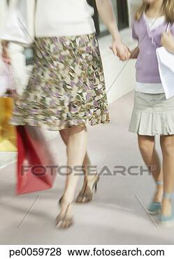 Stock Photo - woman and young 
girl outdoors 
with shopping 
bags. fotosearch 
- search stock 
photos, pictures, 
images, and photo 
clipart