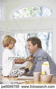 Stock Photograph - young boy tying 
man's necktie 
in kitchen. fotosearch 
- search stock 
photos, pictures, 
images, and photo 
clipart