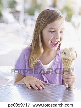 Picture - young girl on 
outdoor patio 
with ice cream 
cone. fotosearch 
- search stock 
photos, pictures, 
images, and photo 
clipart