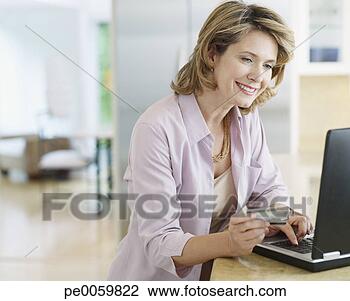 Banco de Imagem - mulher,  cozinha, 
 crédito,  cartão, 
 laptop. fotosearch 
- busca de fotos, 
imagens e clipart