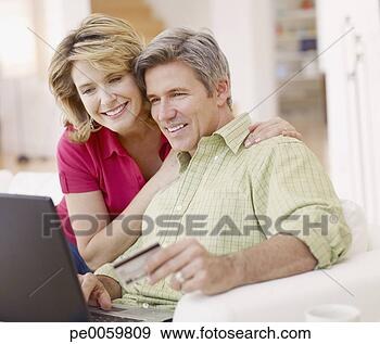 Arquivo Fotográficos - par,  vivendo, 
 sala,  laptop, 
 crédito,  cartão. 
fotosearch - busca 
de fotos, imagens 
e clipart