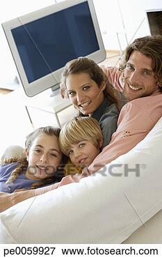 Picture - family in living 
room on sofa bonding. 
fotosearch - search 
stock photos, 
pictures, images, 
and photo clipart