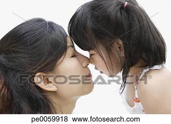 Stock Photo - woman and young 
girl indoors touching 
noses. fotosearch 
- search stock 
photos, pictures, 
images, and photo 
clipart