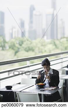 Stock Photograph - businesswoman 
on outdoor patio 
eating lunch. 
fotosearch - search 
stock photos, 
pictures, images, 
and photo clipart