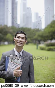 Stock Photograph - businessman outdoors 
in park with newspaper. 
fotosearch - search 
stock photos, 
pictures, images, 
and photo clipart