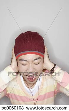 Stock Photo - man indoors screaming 
and covering ears. 
fotosearch - search 
stock photos, 
pictures, images, 
and photo clipart