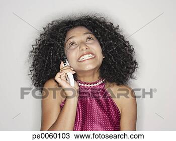 Stock Photo - woman indoors 
on her mobile 
phone. fotosearch 
- search stock 
photos, pictures, 
images, and photo 
clipart
