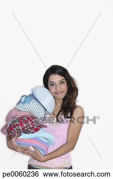 Stock Photo - woman indoors 
holding pile of 
hats. fotosearch 
- search stock 
photos, pictures, 
images, and photo 
clipart