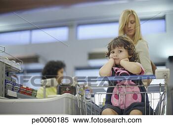 Stock Image - young girl in 
grocery store 
with woman at 
check-out. fotosearch 
- search stock 
photos, pictures, 
images, and photo 
clipart