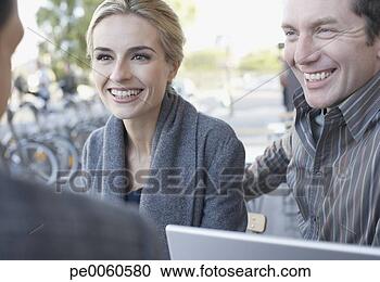 Stock Photography - couple and man 
on outdoor patio 
with laptop. fotosearch 
- search stock 
photos, pictures, 
images, and photo 
clipart