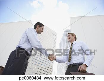 Stock Photo - two businessmen 
outdoors shaking 
hands. fotosearch 
- search stock 
photos, pictures, 
images, and photo 
clipart