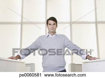 Stock Photography - businessman standing 
in an office between 
cubicles. fotosearch 
- search stock 
photos, pictures, 
images, and photo 
clipart