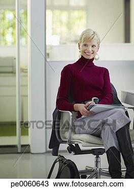 Stock Photo - businesswoman 
sitting in office 
with paperwork. 
fotosearch - search 
stock photos, 
pictures, images, 
and photo clipart