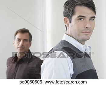Stock Photo - two businessmen 
in corridor looking 
at camera. fotosearch 
- search stock 
photos, pictures, 
images, and photo 
clipart