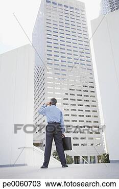 Stock Photo - businessman outdoors 
on his mobile 
phone. fotosearch 
- search stock 
photos, pictures, 
images, and photo 
clipart