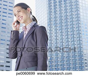 Stock Photograph - businesswoman 
outdoors on her 
mobile phone. 
fotosearch - search 
stock photos, 
pictures, images, 
and photo clipart