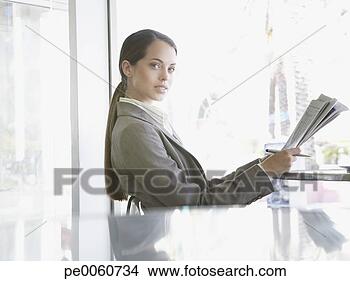 Stock Photo - businesswoman 
sitting on outdoor 
patio with newspaper. 
fotosearch - search 
stock photos, 
pictures, images, 
and photo clipart