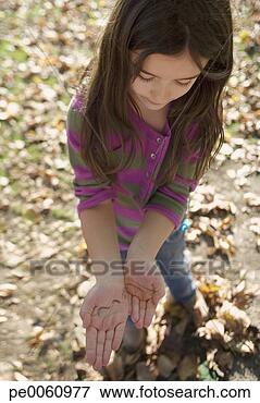 Picture - young girl outdoors 
holding an earthworm. 
fotosearch - search 
stock photos, 
pictures, images, 
and photo clipart