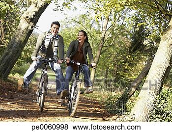 Stock Photo - couple outdoors 
having fun riding 
bicycles. fotosearch 
- search stock 
photos, pictures, 
images, and photo 
clipart