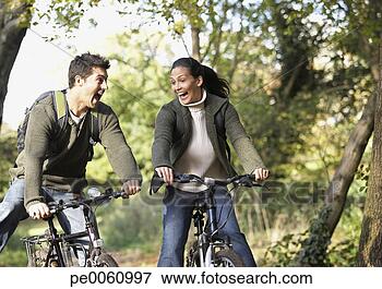 Foto - par,  ao ar livre, 
 tendo,  divertimento, 
 montando,  bicycles. 
fotosearch - busca 
de fotos, imagens 
e clipart