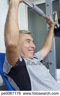 Stock Photo - man in gym lifting 
weights. fotosearch 
- search stock 
photos, pictures, 
images, and photo 
clipart