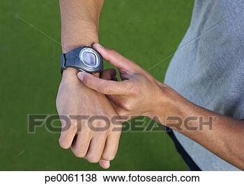 Stock Photo - man's hands using 
wristwatch outdoors. 
fotosearch - search 
stock photos, 
pictures, images, 
and photo clipart