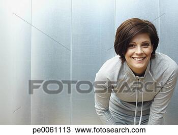 Banco de Imagem - mulher,  dobrado, 
 locker,  sala, 
 olhar,  câmera. 
fotosearch - busca 
de fotos, imagens 
e clipart