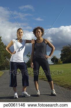 Stock Photo - two women standing 
outdoors on a 
path in a park. 
fotosearch - search 
stock photos, 
pictures, images, 
and photo clipart