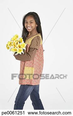 Stock Photography - young girl indoors 
holding bouquet 
of flowers. fotosearch 
- search stock 
photos, pictures, 
images, and photo 
clipart