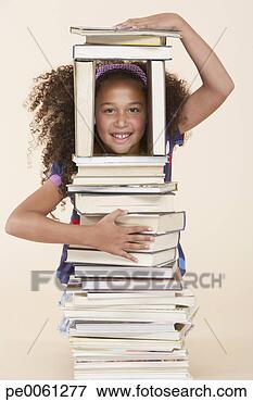Picture - young girl playing 
with books indoors. 
fotosearch - search 
stock photos, 
pictures, images, 
and photo clipart