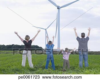 Stock Photo - family standing 
outdoors by windmills 
with arms up in 
air. fotosearch 
- search stock 
photos, pictures, 
images, and photo 
clipart