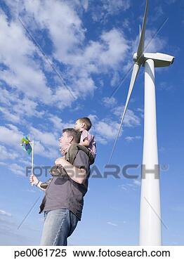 Stock Image - man holding toy 
windmill with 
young boy on shoulders 
standing by real. 
fotosearch - search 
stock photos, 
pictures, images, 
and photo clipart