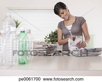 Stock Photography - woman in kitchen 
with recyclable 
materials smiling. 
fotosearch - search 
stock photos, 
pictures, images, 
and photo clipart
