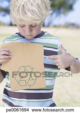 Stock Photo - young boy holding 
piece of cardboard 
with recycle symbol 
and pointing. 
fotosearch - search 
stock photos, 
pictures, images, 
and photo clipart