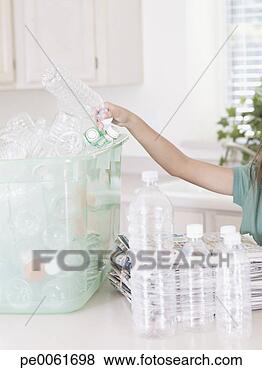 Stock Photo - young girl in 
kitchen with recyclable 
materials and 
bin. fotosearch 
- search stock 
photos, pictures, 
images, and photo 
clipart