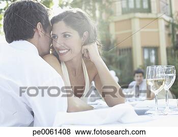 Stock Photo - couple at outdoor 
party whispering 
and smiling. fotosearch 
- search stock 
photos, pictures, 
images, and photo 
clipart