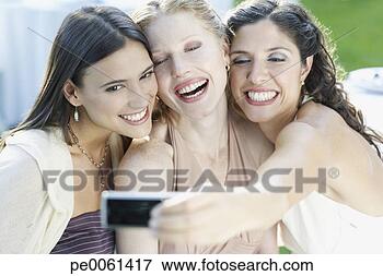 Picture - three women at 
an outdoor party 
taking a self-portrait 
with a digital. 
fotosearch - search 
stock photos, 
pictures, images, 
and photo clipart