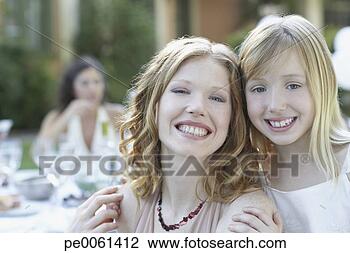 Stock Photo - woman and young 
girl outdoors 
embracing and 
smiling. fotosearch 
- search stock 
photos, pictures, 
images, and photo 
clipart