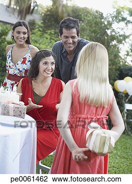 Stock Photo - young girl at 
outdoor birthday 
party about to 
give gift to woman 
with. fotosearch 
- search stock 
photos, pictures, 
images, and photo 
clipart