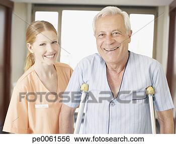 Stock Photo - hospital worker 
helping senior 
man in hospital 
corridor using. 
fotosearch - search 
stock photos, 
pictures, images, 
and photo clipart