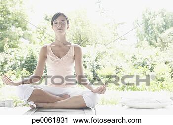 Stock Photography - woman outdoors 
on patio doing 
yoga. fotosearch 
- search stock 
photos, pictures, 
images, and photo 
clipart